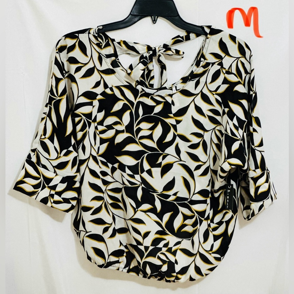LADIES WHITE TOP WITH BLACK & YELLOW LEAF DESIGNS